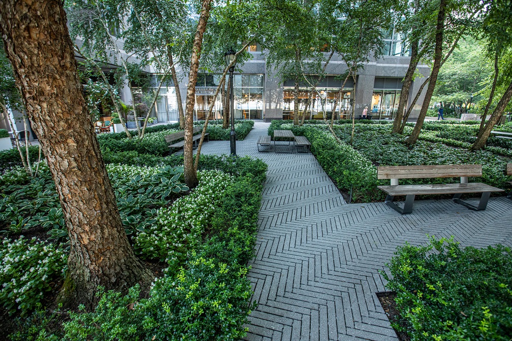 This pristine landscape located in Downtown Manhattan includes an architectural hardscaped paver path, a pristine lawn area