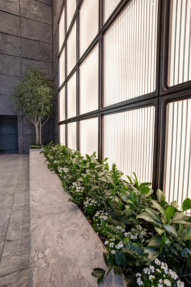 Preserved, replica trees 'breathe' life into this powerful lobby, anchored by live underplantings
