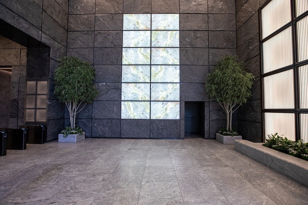 Preserved, replica trees 'breathe' life into this powerful lobby, anchored by live underplantings