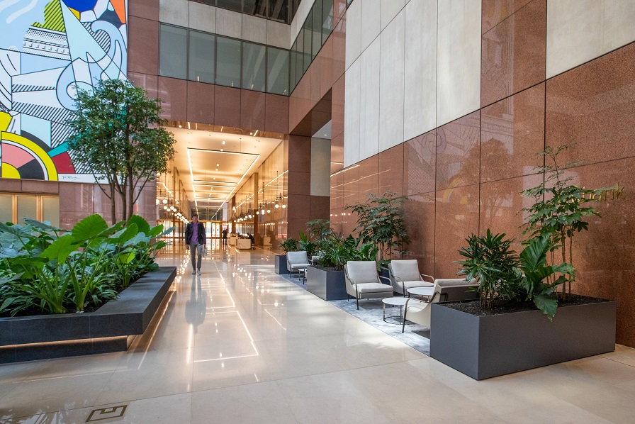 Four large trees help to anchor this expansive lobby, where you can rendezvous admist the rich green foliage.